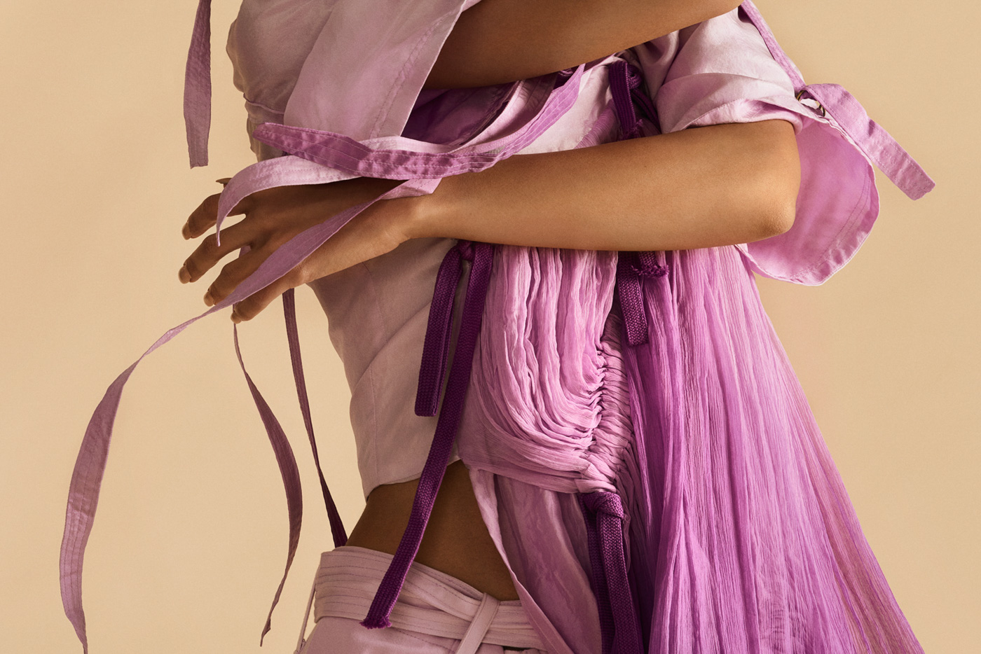 weird_studio_fashion_editorial_portrait_of_dancer_Miranda_Chambers_wearing_purple_on_beige_background_photographed_by_Sara_Lehtomaa