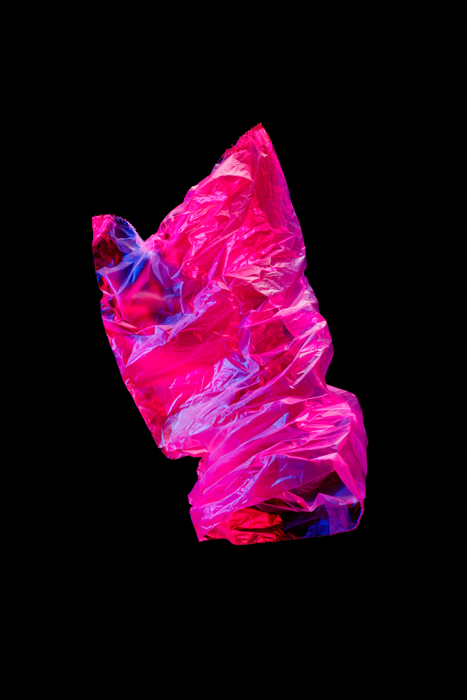 A_red_and_blue_lighted_plastic_bag_floating_in_the_air_with_a_black_background_by_Elina_Himanen