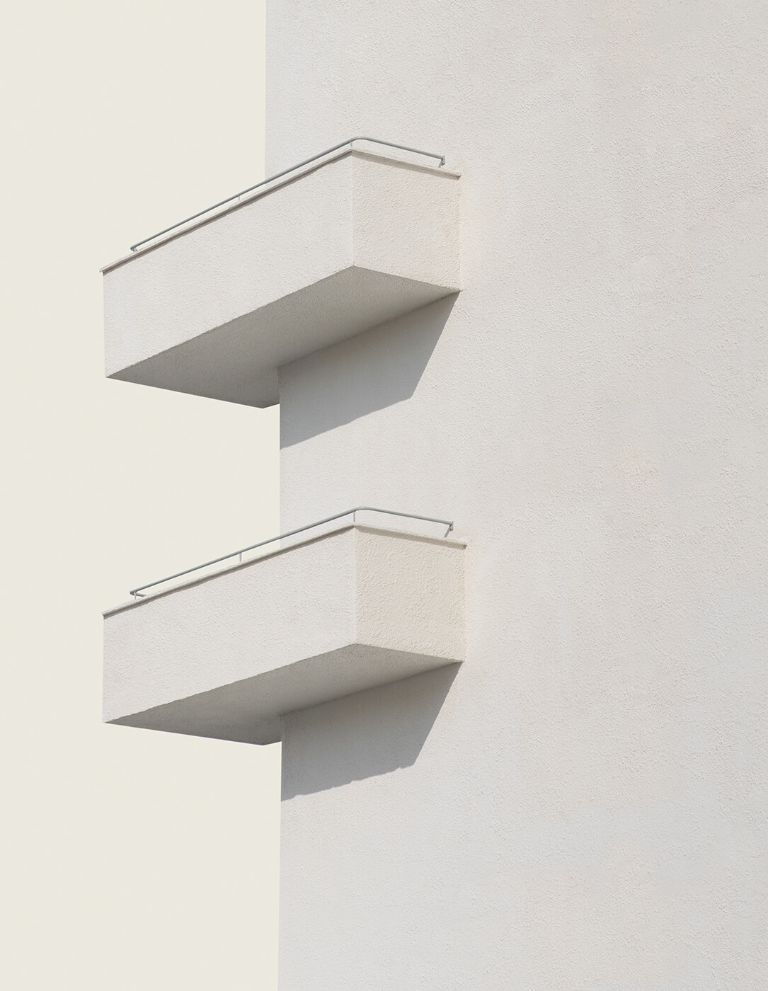 A minimalistic architectural image of a building with two balconies