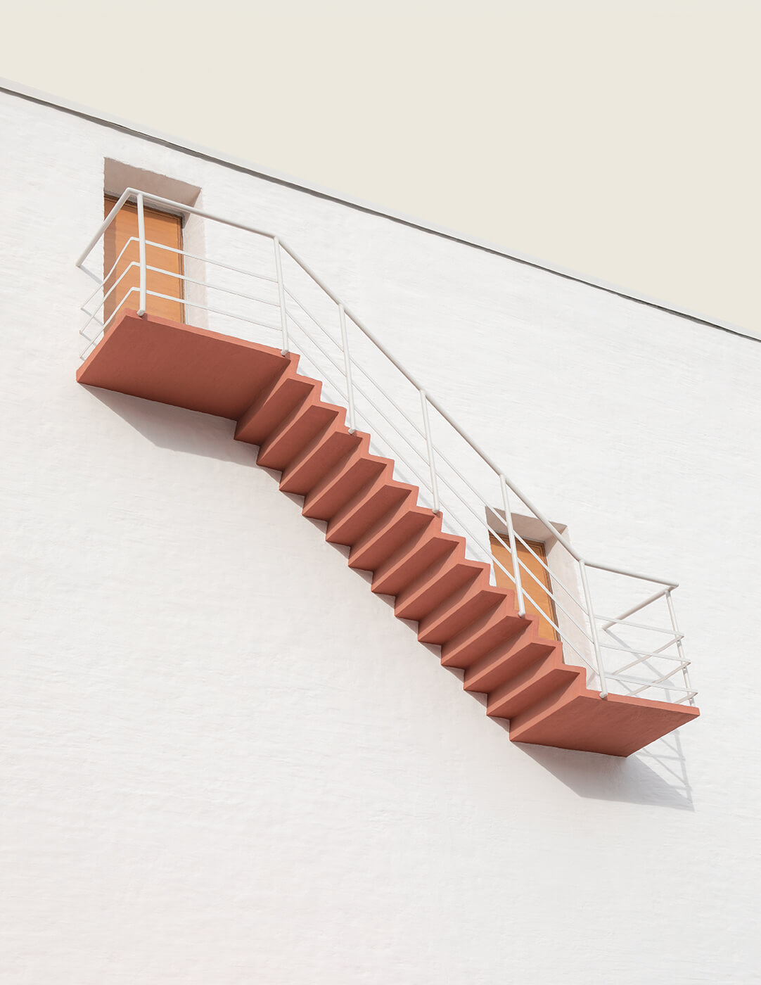 A minimalistic architectural image of two doors and a stair outside a building