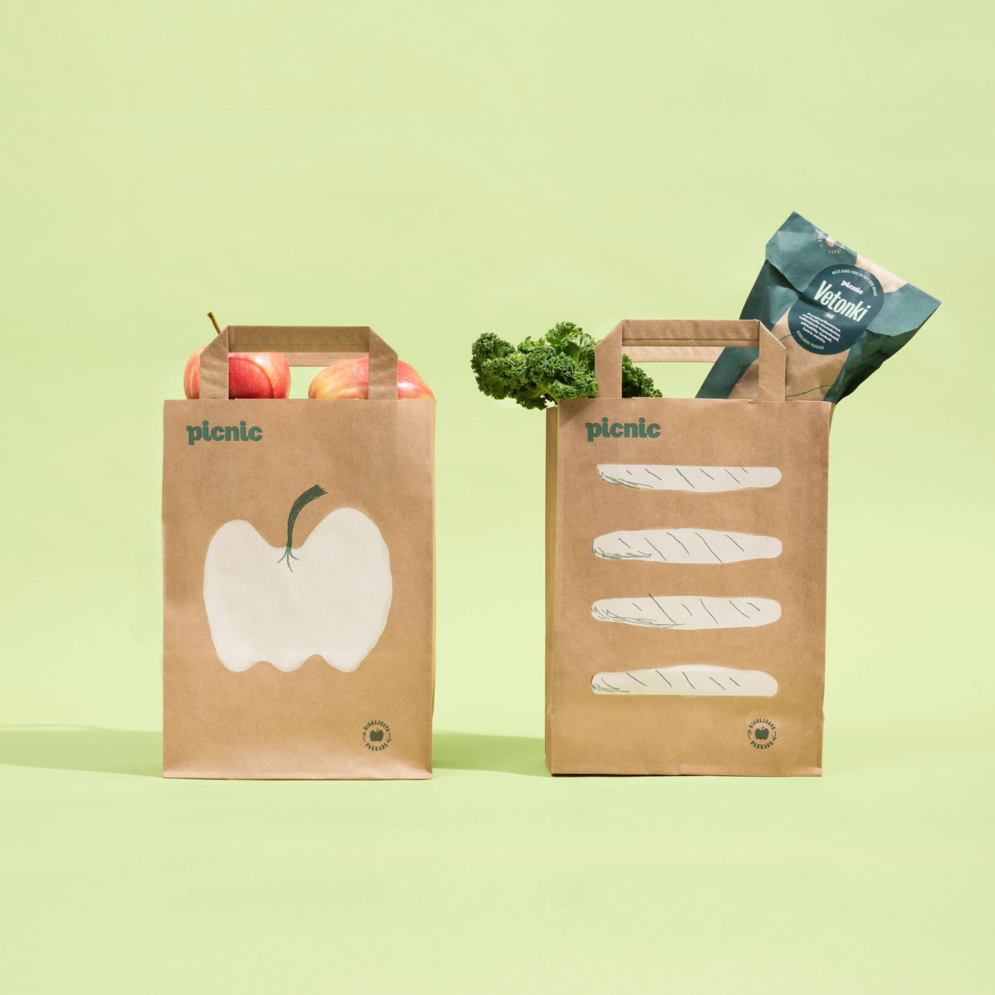two paper bags filled with groceries on a light green background by Tomas Olsen
